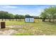 Exterior of a small, metal barn with doors in a fenced-in pasture, providing ample space at 15465 Se 113Th Street Rd, Ocklawaha, FL 32179