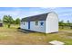 Side view of a blue barn with a black roof and blue stars, located in a grassy pasture at 15465 Se 113Th Street Rd, Ocklawaha, FL 32179