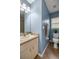 Bathroom featuring blue walls, modern vanity, and toilet with tile floors at 15465 Se 113Th Street Rd, Ocklawaha, FL 32179