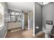 Well-lit bathroom with double vanity, glass-enclosed shower, and neutral tile flooring at 15465 Se 113Th Street Rd, Ocklawaha, FL 32179