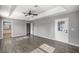 Spacious bedroom with tray ceiling, modern ceiling fan, and wood-look flooring at 15465 Se 113Th Street Rd, Ocklawaha, FL 32179
