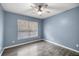 Bedroom features wood-look floors, blue walls, and ceiling fan at 15465 Se 113Th Street Rd, Ocklawaha, FL 32179