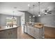 Bright kitchen featuring stainless steel appliances, modern cabinetry, and a breakfast bar with pendant lighting at 15465 Se 113Th Street Rd, Ocklawaha, FL 32179