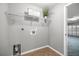 Laundry room featuring utility sink and built-in shelving at 15465 Se 113Th Street Rd, Ocklawaha, FL 32179