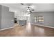 Open floorplan showcasing a kitchen with stainless appliances, breakfast bar, tile floors, and a ceiling fan at 15465 Se 113Th Street Rd, Ocklawaha, FL 32179