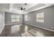 Spacious main bedroom with wood-look floors, ceiling fan, and natural light at 15465 Se 113Th Street Rd, Ocklawaha, FL 32179