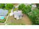Aerial view of a private home featuring mature trees, sparkling pool, and large lot at 1617 Se 29Th Ter, Ocala, FL 34471