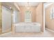 Well-lit bathroom with a glass shower, soaking tub, vanity area, and tile flooring at 1617 Se 29Th Ter, Ocala, FL 34471
