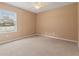 This bedroom has neutral carpet, a ceiling fan, a window overlooking the yard, and ample space at 1617 Se 29Th Ter, Ocala, FL 34471