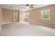 Spacious carpeted bedroom with neutral paint, ceiling fan, and windows providing ample natural light at 1617 Se 29Th Ter, Ocala, FL 34471