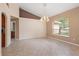 Open dining room featuring tile floors, neutral paint, decorative lighting, and a large arched window at 1617 Se 29Th Ter, Ocala, FL 34471