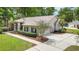 Spacious driveway leading to a two-car garage, surrounded by well-kept landscaping and mature trees at 1617 Se 29Th Ter, Ocala, FL 34471