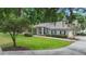 Charming home with a green lawn and landscaped front yard, complemented by lush surrounding trees at 1617 Se 29Th Ter, Ocala, FL 34471