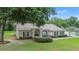 Well-maintained home with green lawn, landscaped front yard, and mature trees at 1617 Se 29Th Ter, Ocala, FL 34471