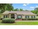 Charming single-story home with a well-manicured lawn, arched entryway, and inviting curb appeal at 1617 Se 29Th Ter, Ocala, FL 34471