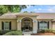 Inviting front entrance with a decorative archway, black door, and manicured landscaping at 1617 Se 29Th Ter, Ocala, FL 34471
