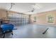 Spacious two car garage with neutral paint, two windows, garage door, and plenty of room for storage at 1617 Se 29Th Ter, Ocala, FL 34471