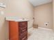 Cozy laundry room featuring tile floors, base cabinets with sink, and hookups for a washer and dryer at 1617 Se 29Th Ter, Ocala, FL 34471