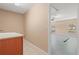 Cozy laundry room featuring tile floors, base cabinets with sink, and doorway to garage at 1617 Se 29Th Ter, Ocala, FL 34471