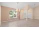 Open living room with tile floors, neutral walls, decorative lighting, columns, and an arched front entry at 1617 Se 29Th Ter, Ocala, FL 34471