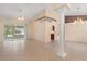 Bright, open living room with tile flooring, a decorative column, and a large sliding glass door at 1617 Se 29Th Ter, Ocala, FL 34471