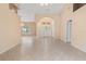 Spacious living room featuring tile floors, neutral walls, decorative lighting, columns, and an arched front entry at 1617 Se 29Th Ter, Ocala, FL 34471
