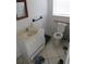 Bathroom featuring a toilet and sink with cabinet at 1737 Griffin Ave, Lady Lake, FL 32159