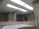 Bathroom features a white soaking tub with tile surround and skylight at 1737 Griffin Ave, Lady Lake, FL 32159