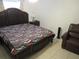 Bedroom with large bed and chair at 1737 Griffin Ave, Lady Lake, FL 32159
