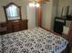 Bedroom with a large bed, wooden accents, and a dresser with a mirror at 1737 Griffin Ave, Lady Lake, FL 32159