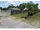 Ranch-style home with green roof, white fence and black post fence surrounding the perimeter of the property at 1737 Griffin Ave, Lady Lake, FL 32159