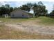 Exterior view of home and side yard on a lot surrounded by mature trees at 1737 Griffin Ave, Lady Lake, FL 32159