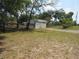 Exterior view of a ranch-style home with a green roof and a black post fence along the side of the property at 1737 Griffin Ave, Lady Lake, FL 32159