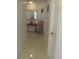 Hallway with a light color and bright tiled floors creating a peaceful transition between rooms at 1737 Griffin Ave, Lady Lake, FL 32159