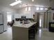Open kitchen with white cabinets, skylights and a large island, perfect for dining and entertaining at 1737 Griffin Ave, Lady Lake, FL 32159