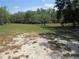 Open lot with patchy sand and grass underneath a partly cloudy sky at 1737 Griffin Ave, Lady Lake, FL 32159