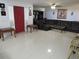 Bright living room with tile floor, comfy leather seating, and red front door at 1737 Griffin Ave, Lady Lake, FL 32159