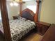 Bedroom with hardwood floors and a striking four-poster bed at 1737 Griffin Ave, Lady Lake, FL 32159