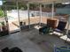 Enclosed patio with concrete floor, chairs, and view of pool with white fence at 1737 Griffin Ave, Lady Lake, FL 32159