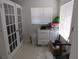 A cluttered room with white walls, french doors and a window at 1737 Griffin Ave, Lady Lake, FL 32159