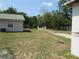 Exterior view of home with green lawn and fence lining the property at 1737 Griffin Ave, Lady Lake, FL 32159