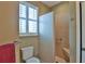 Bathroom featuring a glass-enclosed shower with tiled walls, shower seat, and grab bar at 2550 Nw 55Th Avenue Rd, Ocala, FL 34482