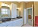 Bathroom showcasing double sinks, granite countertops, white cabinetry and walk-in to bedroom at 2550 Nw 55Th Avenue Rd, Ocala, FL 34482