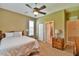 Bright bedroom featuring a ceiling fan, natural light, and a closet for ample storage at 2550 Nw 55Th Avenue Rd, Ocala, FL 34482