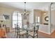 Elegant dining area featuring a glass-top table, ornate chairs, and a large window with plantation shutters at 2550 Nw 55Th Avenue Rd, Ocala, FL 34482