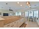 Modern kitchen features granite countertops, white cabinetry, and an open view to the dining area and living room at 2550 Nw 55Th Avenue Rd, Ocala, FL 34482