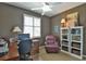 Home office with built-in bookshelves, comfortable seating, and ample natural light at 2550 Nw 55Th Avenue Rd, Ocala, FL 34482