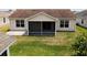Aerial view of a screened-in back porch with a concrete patio and green grass at 2594 Berrington Loop, The Villages, FL 32162
