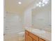 Bathroom featuring a shower and tub combo, a sink, and wood-finished cabinets at 2594 Berrington Loop, The Villages, FL 32162