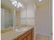 Bright bathroom featuring a vanity with sink, a large mirror, and modern lighting at 2594 Berrington Loop, The Villages, FL 32162